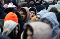 Refugees from Ukraine wait in a crowd for transportation after fleeing their homeland and arriving at the border crossing in Medyka, Poland, Monday, 7 March, 2022
