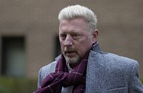 Former tennis player Boris Becker, right, leaves Southwark Crown Court in London on 7 April 2022