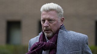 Former tennis player Boris Becker, right, leaves Southwark Crown Court in London on 7 April 2022