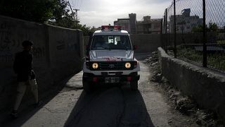An ambulance carrying wounded people leaves the site of an explosion in Kabul.