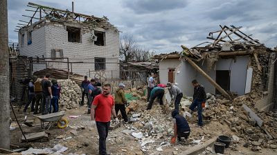 Residents and rescue workers secure homes after a shelling attack in Zaporizhzhia.