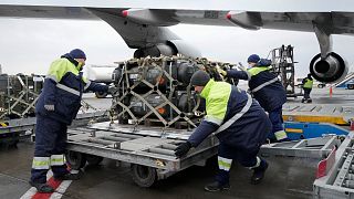 Workers unload a shipment of military aid delivered as part of the United States of America's security assistance to Ukraine, at the Boryspil airport, 11 February.