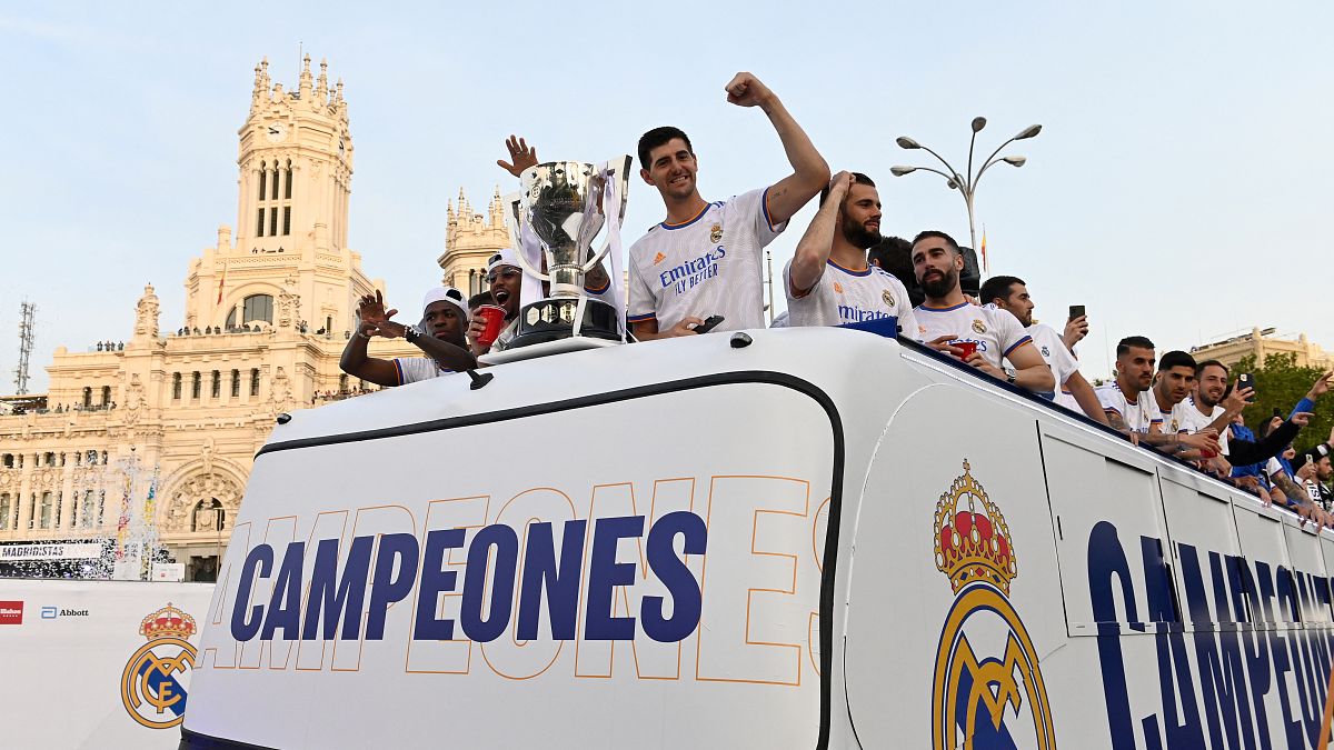 Real Madrid's players celebrate as they arrive on a bus on the Plaza Cibeles square in Madrid.