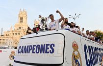 Real Madrid's players celebrate as they arrive on a bus on the Plaza Cibeles square in Madrid.