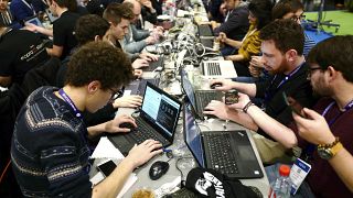 Cyber Security experts take part in a test at the Cybersecurity Conference in Lille, northern France, Tuesday Jan. 22, 2019.