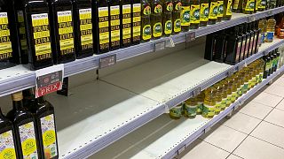 A picture taken on April 5, 2022, shows empty shelves where sunflower oil is usually found at a supermarket in Paris.