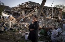 Woman surveys wreckage of her home in Irpin, near Kyiv in Ukraine