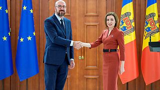 Charles Michel shakes hands with Moldova's President Maia Sandu during their meeting in Chisinau.