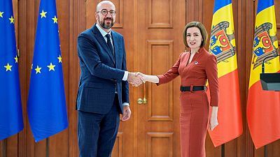 Charles Michel shakes hands with Moldova's President Maia Sandu during their meeting in Chisinau.