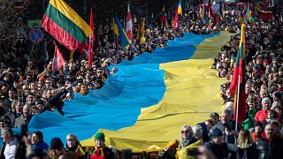 People carry a giant Ukrainian flag to protest against the Russian invasion of Ukraine during a celebration of Lithuania's independence in Vilnius, Lithuania, Friday, March 11