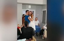 Ukraine nurse who lost legs in landmine explosion dances with new husband in Lviv hospital.