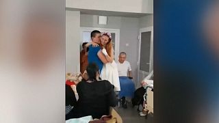 Ukraine nurse who lost legs in landmine explosion dances with new husband in Lviv hospital.