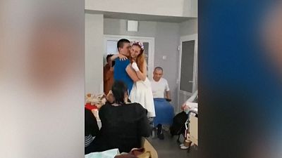 Ukraine nurse who lost legs in landmine explosion dances with new husband in Lviv hospital.