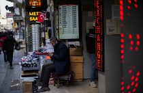 A screen displays exchange rates in a currency exchange shop in a commercial street in Istanbul.