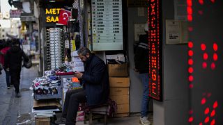 A screen displays exchange rates in a currency exchange shop in a commercial street in Istanbul.