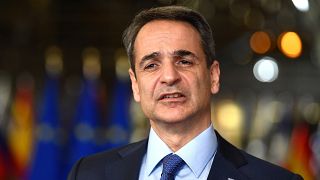 Greek Prime Minister Kyriakos Mitsotakis speaks with the media at the European Council in Brussels.