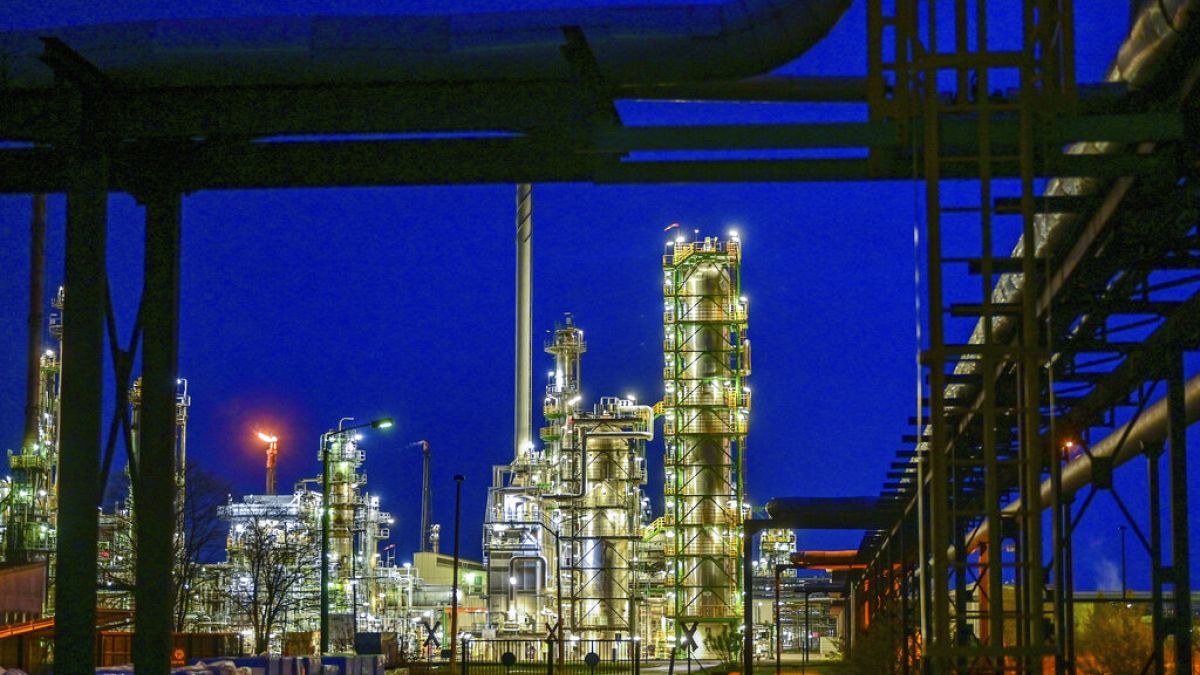 The facilities of the oil refinery on the industrial site of PCK-Raffinerie GmbH are illuminated in the evening in Schwedt, Germany, Wednesday, May 4, 2022