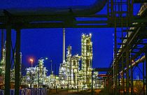 The facilities of the oil refinery on the industrial site of PCK-Raffinerie GmbH are illuminated in the evening in Schwedt, Germany, Wednesday, May 4, 2022