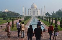 A small number of people visit as the Taj Mahal monument is reopened to tourists.
