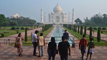 A small number of people visit as the Taj Mahal monument is reopened to tourists.
