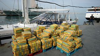 Cocaine weighing some 5.2 tons and a seized yacht are displayed for the media at a Portuguese Navy base in Almada, south of Lisbon, on Oct. 18, 2021.