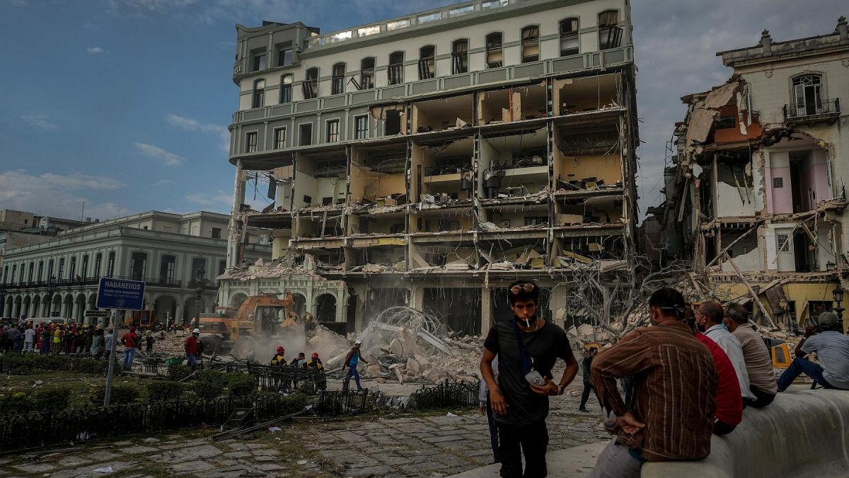 People watch the rescue effort at the site of a deadly explosion that destroyed the five-star Hotel Saratoga, in Havana, Cuba, Friday, May 6, 2022. 