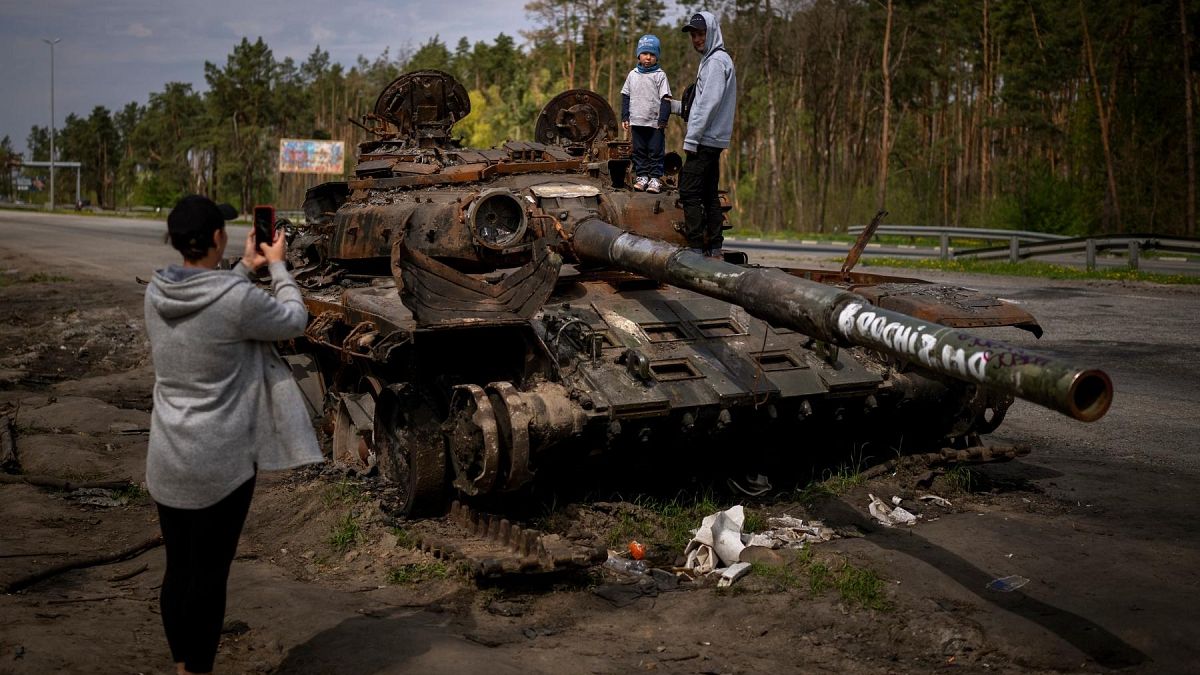 Maksym, 3, is photographed with his brother, Dmytro, 16, on top of a destroyed Russian tank, on the outskirts of Kyiv, Ukraine on Sunday, May 8, 2022.