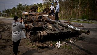 Maksym, 3, is photographed with his brother, Dmytro, 16, on top of a destroyed Russian tank, on the outskirts of Kyiv, Ukraine on Sunday, May 8, 2022.