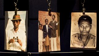 Des photos de famille de personnes assassinées lors du génocide des Tutsis en 1994 sont exposées au mémorial de Kigali, au Rwanda, samedi 5 avril 2014.