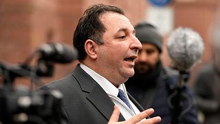 Syrian lawyer Mazen Darwish gives a statement after the verdict in front of the court in Koblenz, Germany, Thursday, Jan. 13, 2022