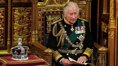 Prince Charles reads the Queen's speech next to her crown during the State Opening of Parliament, at the Palace of Westminster in London, Tuesday, May 10, 2022.