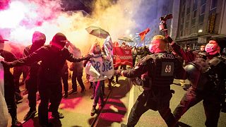 Demonstrators take part in a rally against the curfews and coronavirus restrictions in Frankfurt/Main, Germany, Saturday, April 24, 2021.