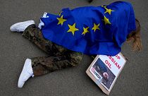 A protestor takes part in a demonstration to call on the European Union to stop buying Russian oil and gas, outside EU headquarters in Brussels, April 29, 2022. 