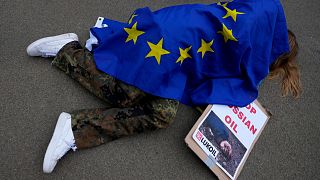 A protestor takes part in a demonstration to call on the European Union to stop buying Russian oil and gas, outside EU headquarters in Brussels, April 29, 2022.