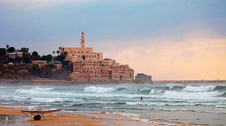 Surfers take to the water on Jaffa Beach, Tel Aviv.