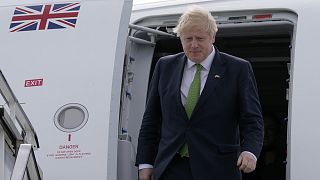 Boris Johnson exits the plane upon arriving at Stockholm's airport on 11 May 2022