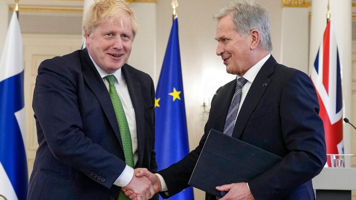 British Prime Minister Boris Johnson, left, and Finland's President Sauli Niinistö shake hands at the Presidential Palace in Helsinki, Finland, Wednesday, May 11, 2022. 