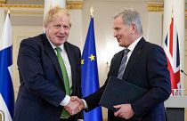 British Prime Minister Boris Johnson, left, and Finland's President Sauli Niinistö shake hands at the Presidential Palace in Helsinki, Finland, Wednesday, May 11, 2022.