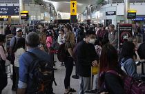 Utazók a biztonsági ellenőrzésnél a londoni Heathrow repülőtéren 2022. június 22-én, szerdán.