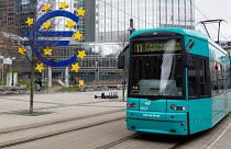 The Euro currency sign is seen in front of the former European Central Bank (ECB) building as a tramway drives past, in Frankfurt am Main, western Germany.