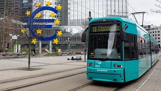 The Euro currency sign is seen in front of the former European Central Bank (ECB) building as a tramway drives past, in Frankfurt am Main, western Germany.