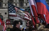QAnon, Russian and Austrian flags seen at an anti-vax rally in Vienna, 12 March 2022