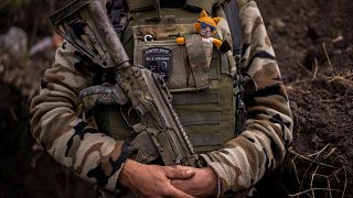 Zhenia, a member of the Ukrainian territorial defence force, guards a position near Kutuzivka, east Ukraine, Friday, May 13, 2022.