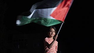 Ένα μικρό κορίτσι με την σημαία της Παλαιστίνης έξω από το σπίτι της δολοφονηθείσας Παλαιστίνιας δημοσιογράφου