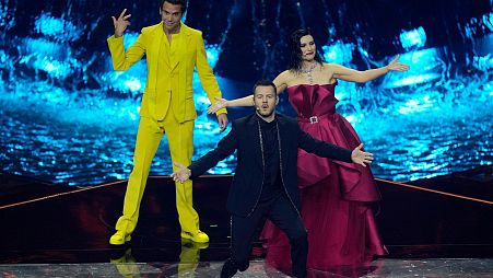 Hosts of the Eurovision Song Contest Laura Pausini, right, stands on stage with Mika, left, and Alessandro Cattelan during the second semi final at the Eurovision Song Contest