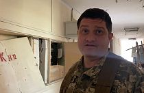 Dmytro Pletenchuk, a public affairs officer for the Mykolaiv regional government, in the remains of his workplace.  