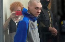 Russian army Sergeant Vadim Shishimarin, 21, is seen behind a glass during a court hearing in Kyiv, Ukraine, Friday, May 13, 2022.