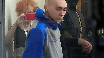 Russian army Sergeant Vadim Shishimarin, 21, is seen behind a glass during a court hearing in Kyiv, Ukraine, Friday, May 13, 2022.