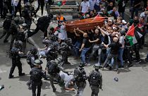 Israeli police confront with mourners as they carry the casket of slain Al Jazeera journalist Shireen Abu Akleh during her funeral in east Jerusalem, Friday, May 13, 2022