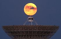 The moon is seen through clouds behind the radio telescope RT-70 in the village of Molochnoye, Crimea May 16, 2022